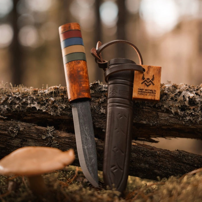 Viking Knife with wooden handle and leather sheath on a textured surface